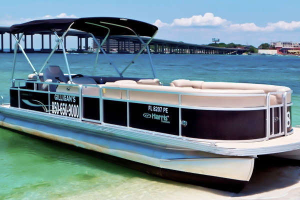 Large Black Pontoon Boat docked on sand in Destin Harbor