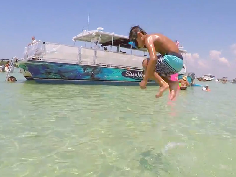 Boy Jumping into Water Crab Island Destin Florida