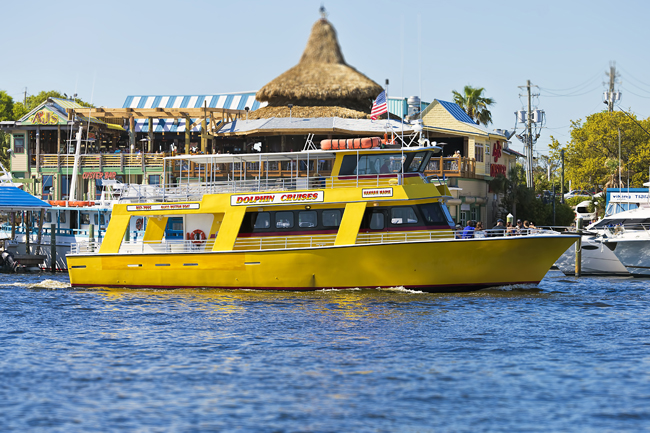 Yellow tour boat cruising down Destin Harbor